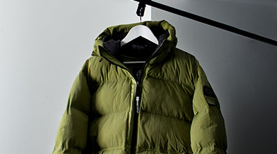ST95 Hooded Puffer Jacket in light green, featuring full zip closure, quilted padding, and sleeve logo badge.