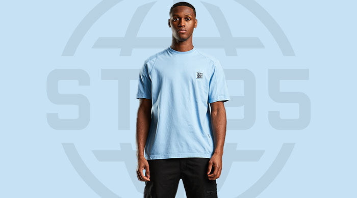 Model wearing the ST95 T-Shirt in white, featuring a classic crew neck design and signature logo patch on the chest.